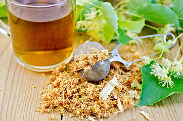 Image showing Herbal tea from linden flowers in a tea strainer with mug