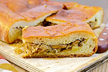 Image showing Pie with cabbage and mushrooms on the board