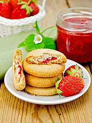 Image showing Biscuits with strawberries and a basket on the board