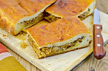 Image showing Pie with cabbage and chanterelles on the board