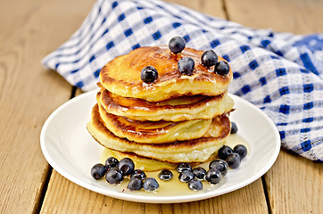 Image showing Flapjacks with blueberries and a napkin on the board