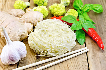 Image showing Noodles rice with spices and broccoli on the board