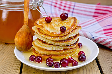 Image showing Flapjacks with cranberry and spoon on board