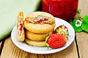 Image showing Biscuits with strawberries and jam on the board