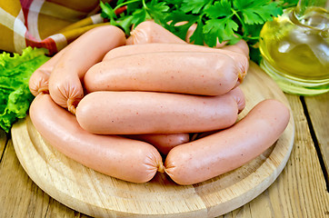 Image showing Sausages on a board with parsley