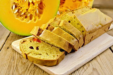 Image showing Fruitcake pumpkin with candied fruits on a board