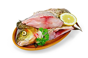 Image showing Bream raw in a clay plate with parsley