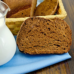 Image showing Rye homemade bread with milk on the board
