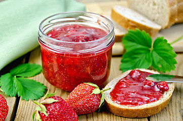 Image showing Jam strawberry with bread on the board