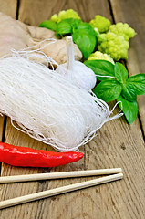 Image showing Noodles rice thin with spices and broccoli on the board