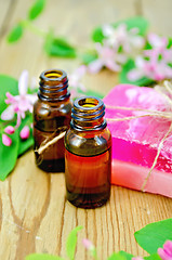 Image showing Oil and pink homemade soap with flowers of honeysuckle