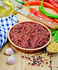 Image showing Adjika with fresh hot peppers and spices on board