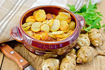 Image showing Jerusalem artichokes fried with parsley in pottery