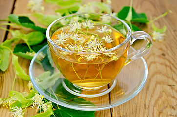 Image showing Herbal tea from linden flowers in a cup on the board