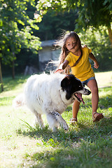 Image showing Little girl with dog running
