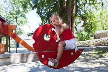 Image showing Little girl on swing in summer park