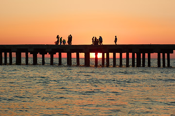 Image showing People on the old sea pier during sunset