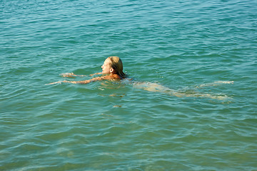 Image showing Teenage girl swimming in sea water