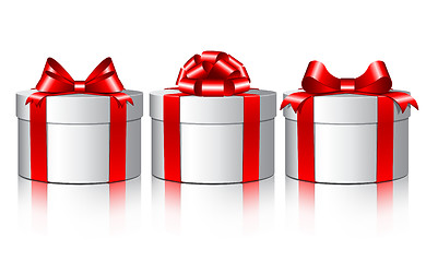 Image showing Three white gift boxes with a red bows.