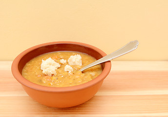 Image showing Vegetable soup with torn bread pieces on top