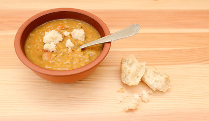 Image showing Thick lentil soup with pieces of bread