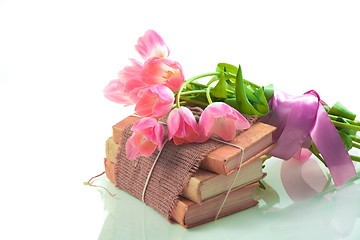 Image showing Pink tulips on old books