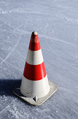 Image showing red white striped cones on the ice rink