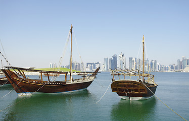 Image showing Traditional wooden dhows and Doha skyline