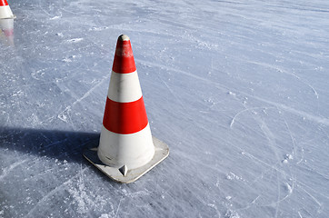 Image showing red white striped cones on the rink