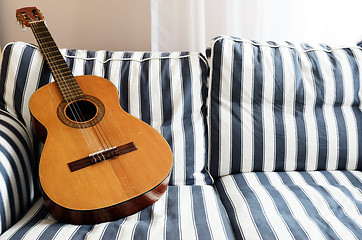 Image showing acoustic guitar on a couch