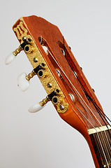 Image showing head guitar neck with tuning pegs on gray