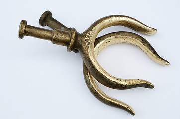 Image showing two bronze oarlocks on a light background