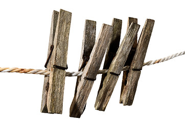 Image showing four old clothes pegs