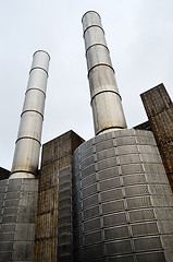 Image showing industrial building and two metal chimney