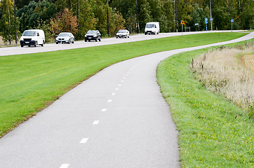 Image showing empty asphalt bike path and motor road 