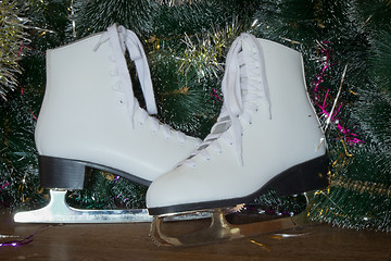 Image showing New year's gift - the beautiful woman skates.