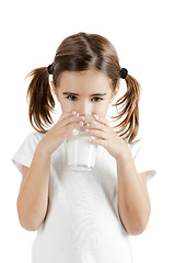 Image showing Little girl drinking milk