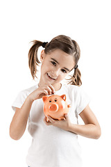 Image showing Little girl with a piggy-bank