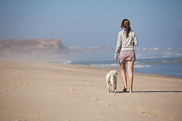 Image showing Walking with her dog