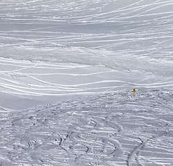 Image showing Traces of skis and snowboards in new fallen snow and warning sig