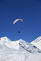 Image showing Paraglider in sunny snowy mountains