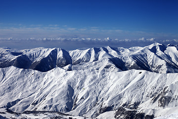 Image showing Snowy mountains and sky with clouds