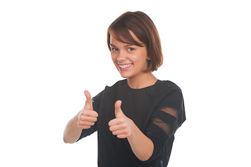 Image showing Teenage girl showing thumbs up and smiling