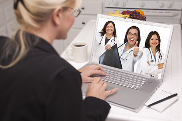 Image showing Woman Using Laptop Viewing Three Doctors with Thumbs Up