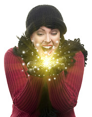 Image showing Excited Woman In Winter Clothes Holds Something Sparkling In Han