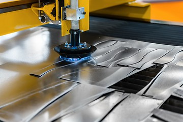 Image showing Machine cutting steel in a factory