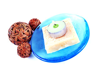 Image showing Soap and candle on a blue glass dish