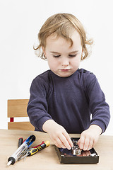 Image showing little girl repairing computer parts