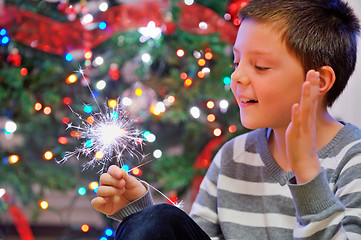 Image showing portrait of boy looking at  fire sparks