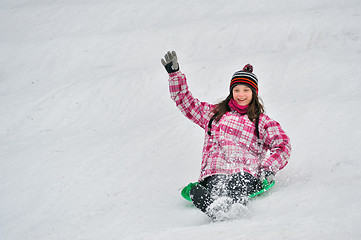 Image showing girl sliding in the snow